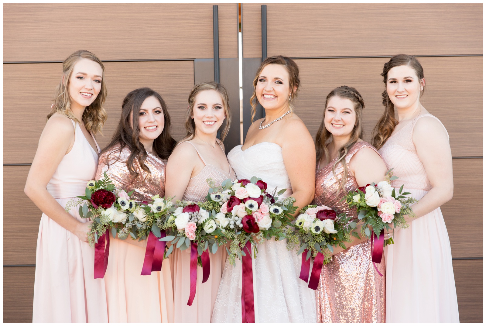 Bridesmaids in blush pink and sparkled dresses outside The Paseo