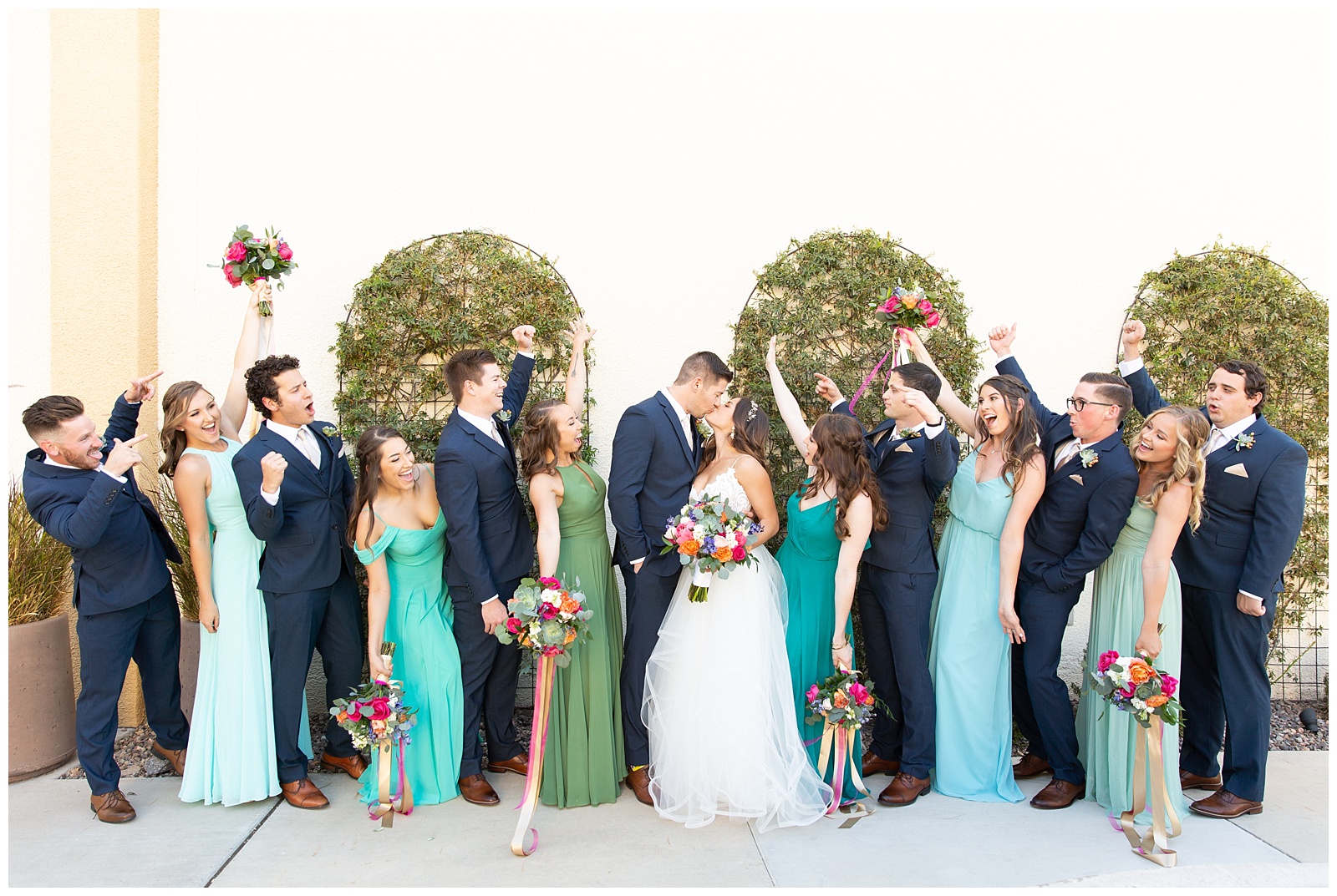 blue and green bridesmaid dresses with colorful bouquets 
